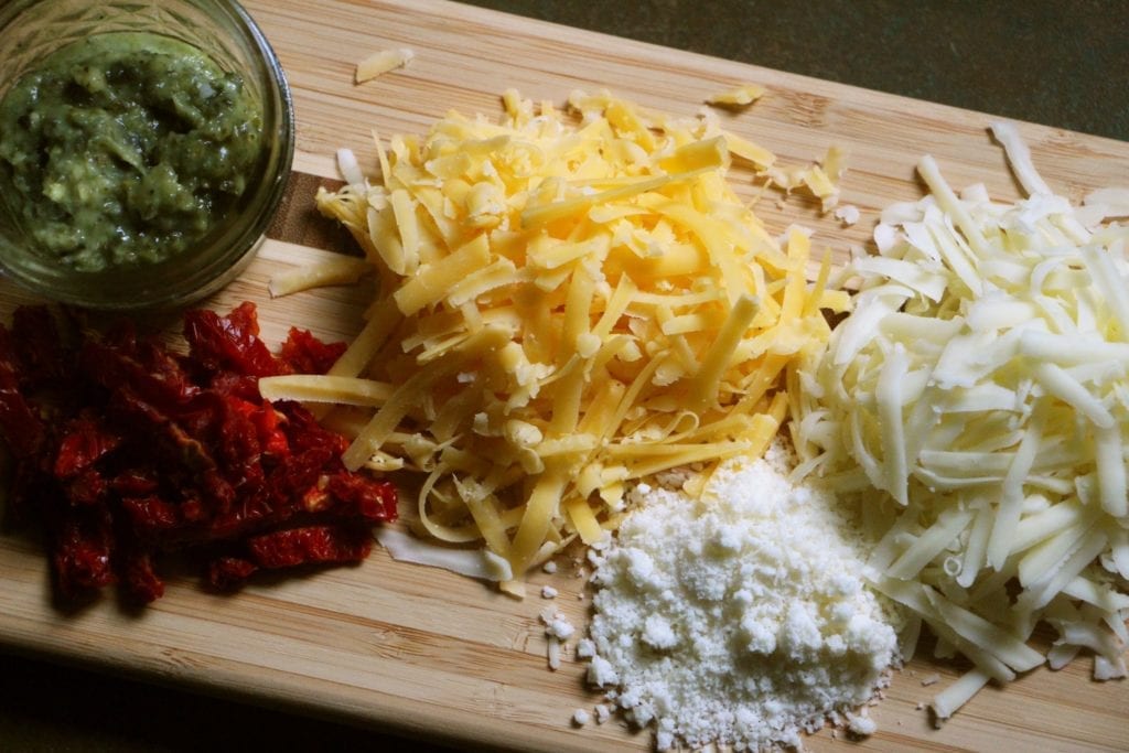 Grated cheeses, pesto and sundried tomatoes