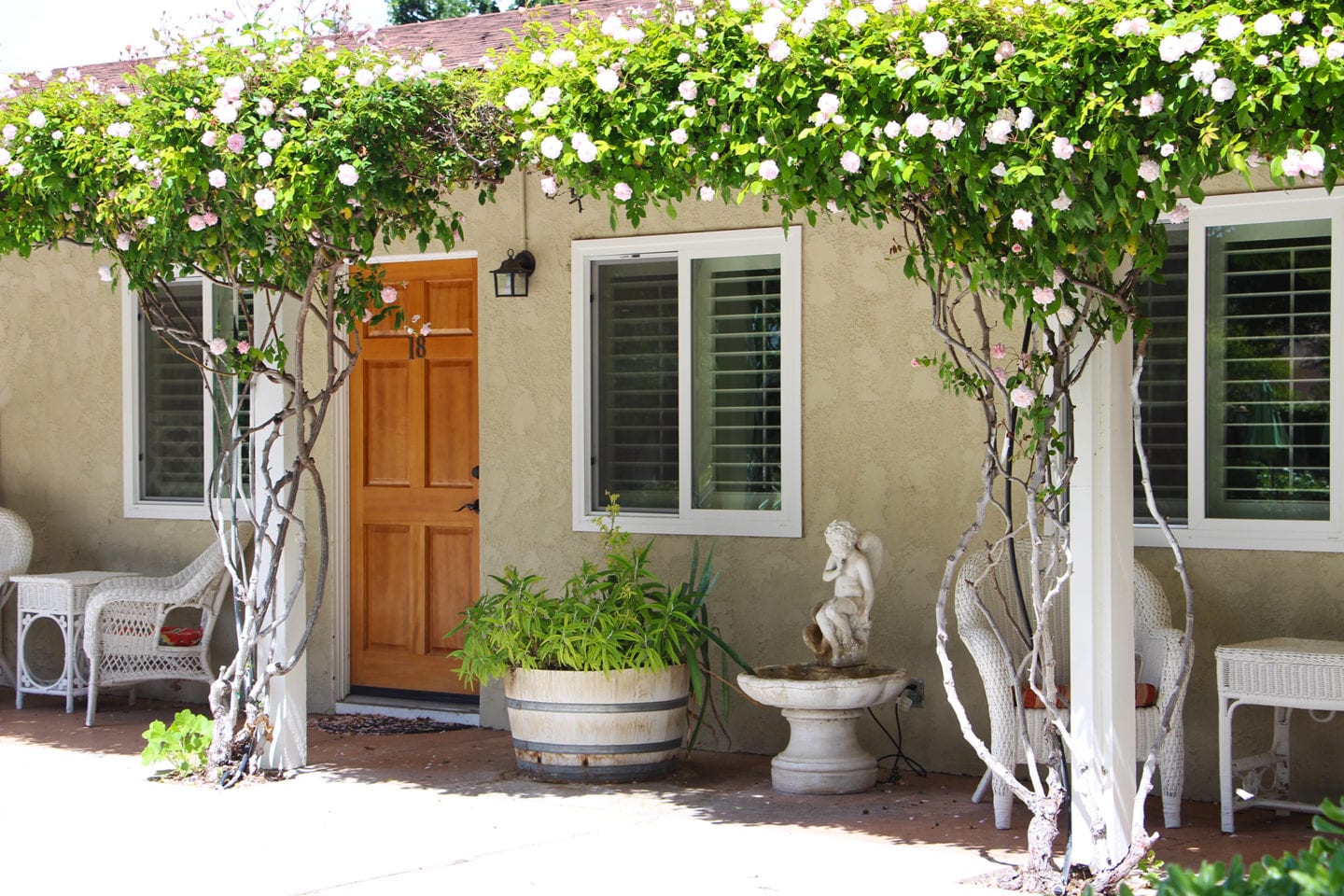 Climbing roses frame the guest rooms at the Meadowlark Inn