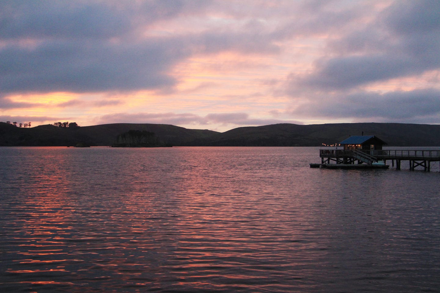 View from Al's Cottage of the pier at sunset at Nick's Cove